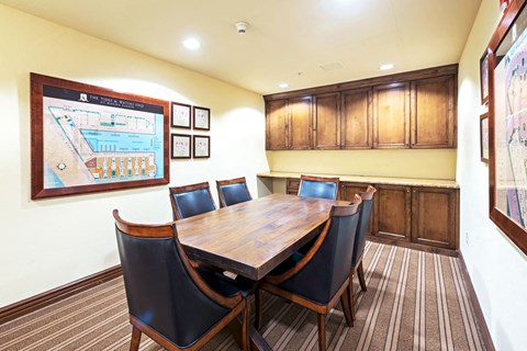 a dining room with a wooden table and chairs